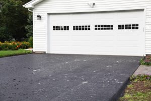 The day after a brand new residential home blacktop asphalt driveway was completed - with overnight rain puddles beading on the still oily surface. This is an "after" photo to go with some "before" photos in my portfolio (below) taken before the old driveway was ripped up a few weeks ago :)