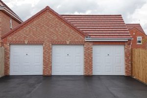 Three new garages in a uk housing development