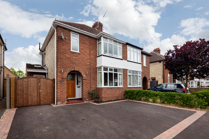 Ely, Cambridgeshire, England - June 20 2018: Typical semi detached bay fronted suburban estate house with driveway providing off road parking
