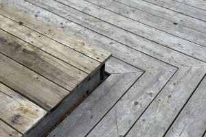 Modern house design with wooden patio, low angle view of hardwood decking